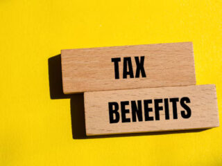 tax-benefits-words-written-wooden-blocks-with-yellow-background-conceptual-tax-benefits-symbol